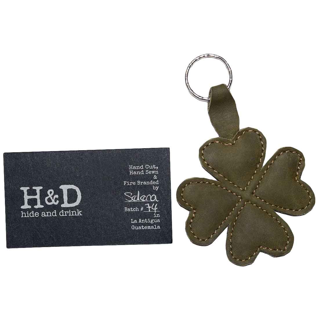 The St. Patrick's - Lucky Clover Keychain by Hide & Drink displayed with its branding card, emphasizing artisan craftsmanship. This lucky clover key organizer holder is made from high-quality full grain leather and represents small batch production from La Antigua Guatemala and Oaxaca Mexico.