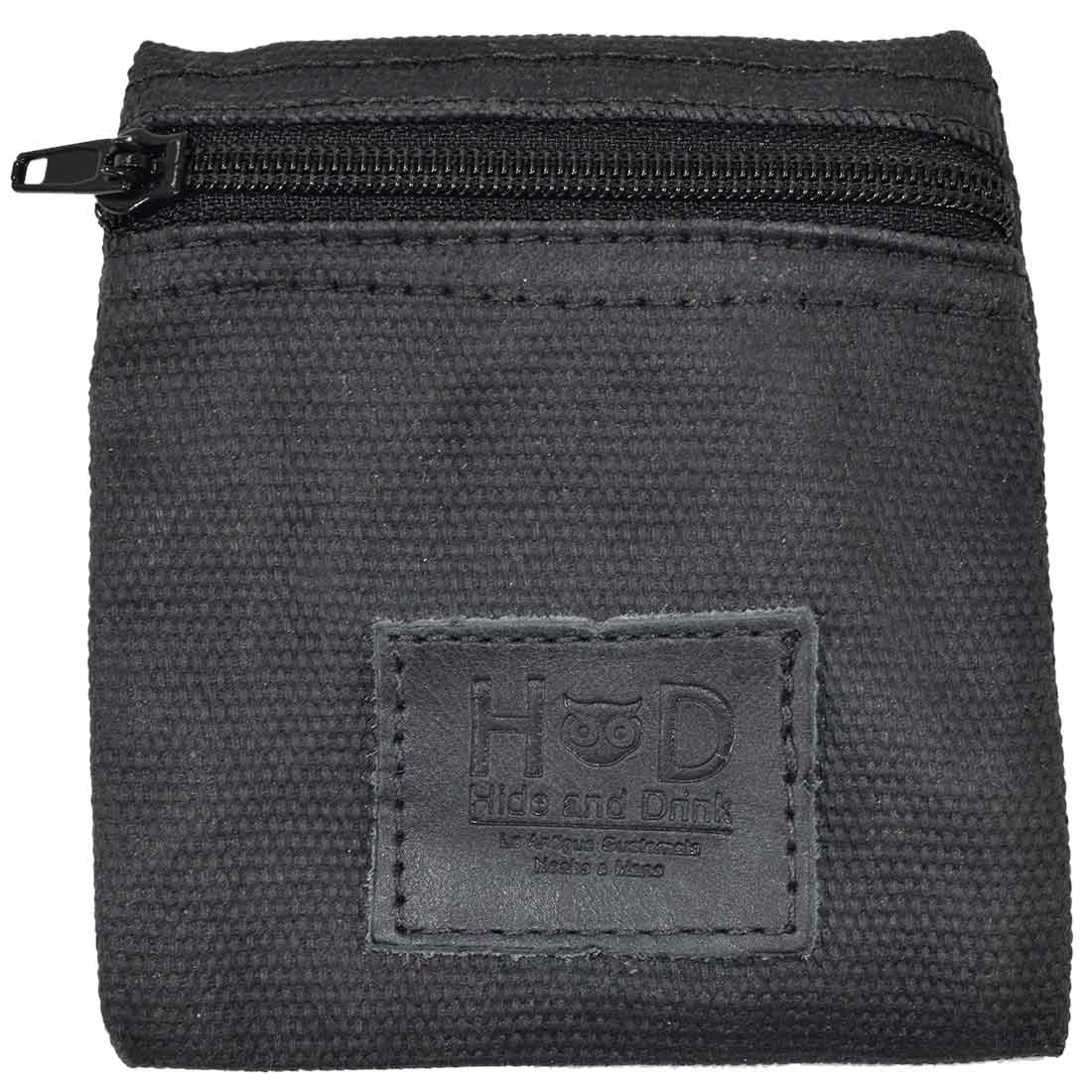 Hide & Drink Condom Pouch displayed with branding card, crafted from strong water resistant waxed canvas. This pouch is ideal for everyday essentials, serving as a classic partner gift and travel accessory. Handmade in La Antigua Guatemala highlights artisanal craftsmanship.