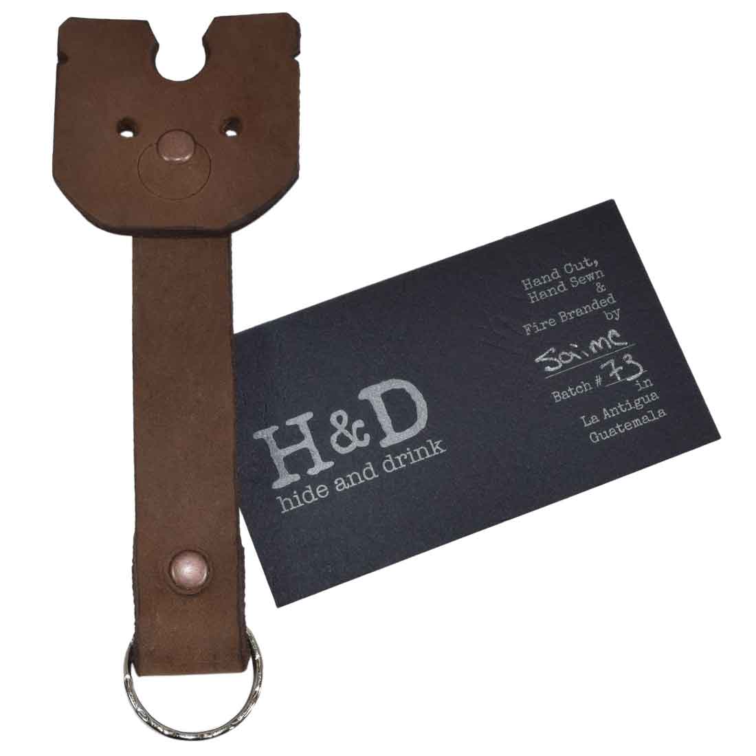 Doggy Fob by Hide & Drink displaying a Full Grain Leather Critter Keychain accompanied by a card detailing its craftsmanship, perfect for thoughtful gifting. Critter Keychain Dog Key Ring Pet Fob, Full Grain Leather, StockyardX, Small Batch Production, Hand Cut, Hand Sewn, Fire Branded, Artisan, Handmade in La Antigua Guatemala & Oaxaca Mexico.