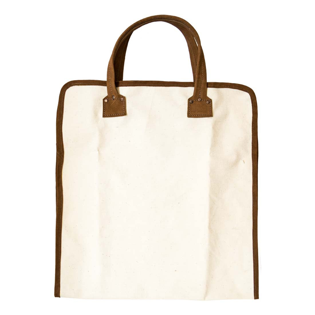Hide & Drink Firewood Bag in an upright position, designed with strong handles and crafted from long-lasting materials, ideal for heavy loads. Firewood Bag With Leather Liner, Full Grain Leather, StockyardX, Small Batch Production, Hand Cut, Hand Sewn, Fire Branded, Artisan, Handmade in La Antigua Guatemala & Oaxaca Mexico.