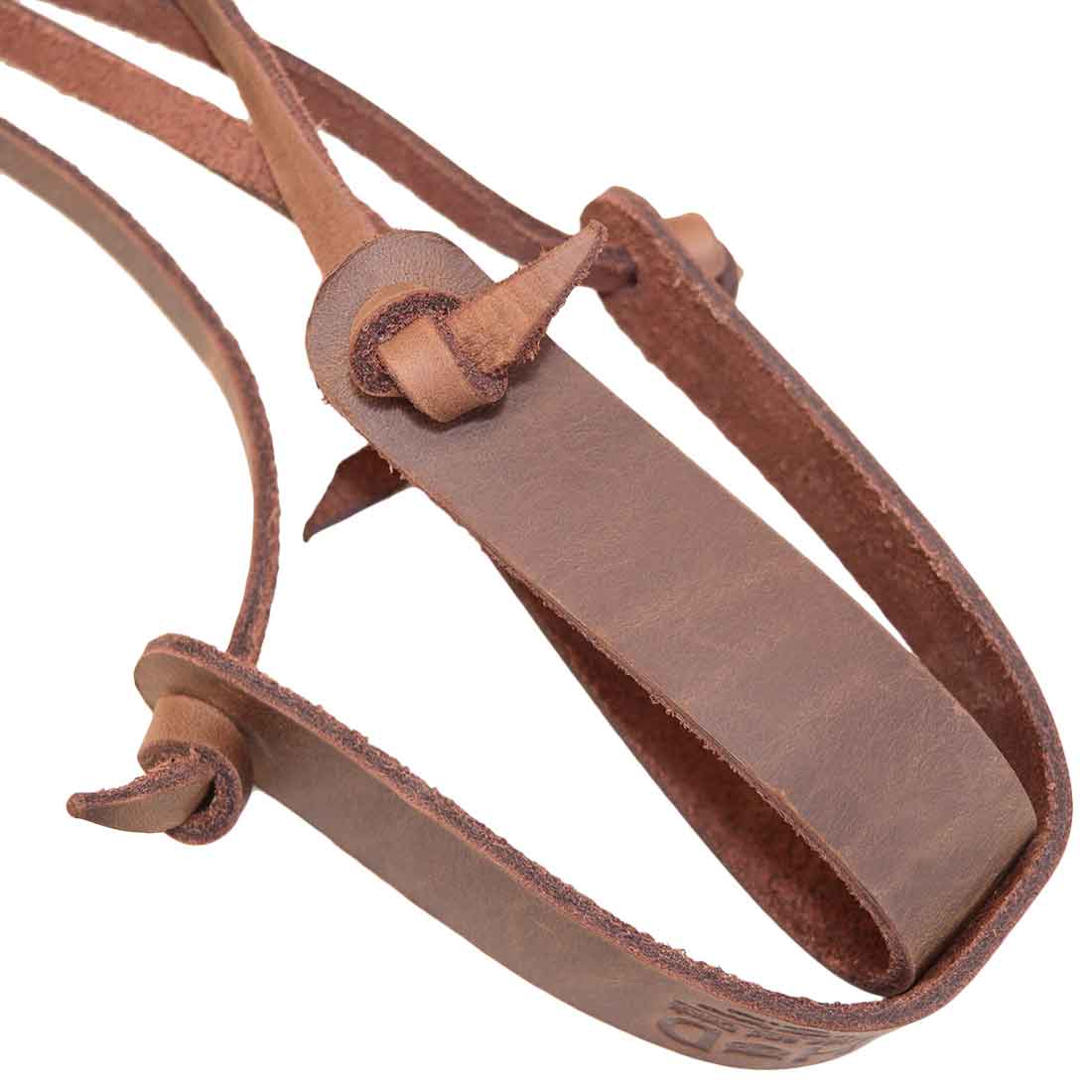 Close-up view of the leather craftsmanship in the Hanging Plant Holder by Hide & Drink, highlighting its hand sewn and hand cut features. This Full Grain Leather Plant Holder is an ideal addition for indoor decoration, representing quality artisan work from small batch production. Experience the unique design and fire branded elements made by artisans in La Antigua Guatemala & Oaxaca Mexico.