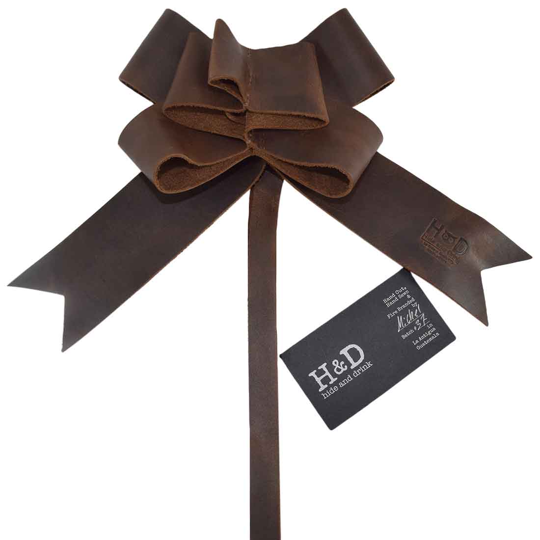 Charming Bourbon Brown Ribbon Decor showcasing a handcrafted bow by Hide & Drink, ideal as a Bow Wrap for Christmas. Made from high-quality Full Grain Leather, this piece reflects artisan skill through small batch production, hand cut and hand sewn design, fire branded in La Antigua Guatemala and Oaxaca Mexico.