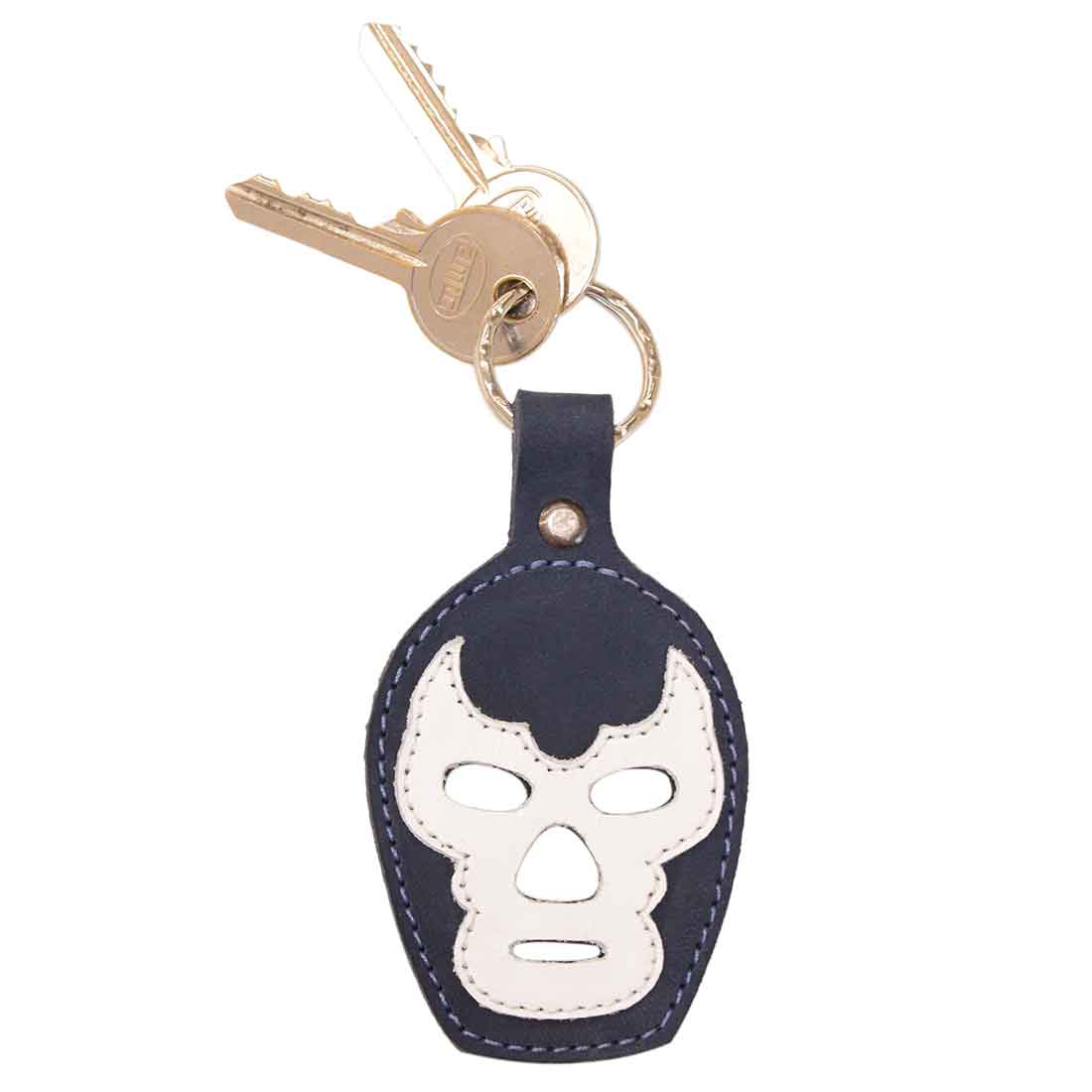 A Luchador Mask Leather Keychain attached to keys, showcasing its stylish design and practicality. This keyring from Hide & Drink is perfect for keeping your keys organized. Constructed from full grain leather, this travel accessory exemplifies small batch production with artisan craftsmanship, hand cut and sewn in La Antigua Guatemala and Oaxaca Mexico.