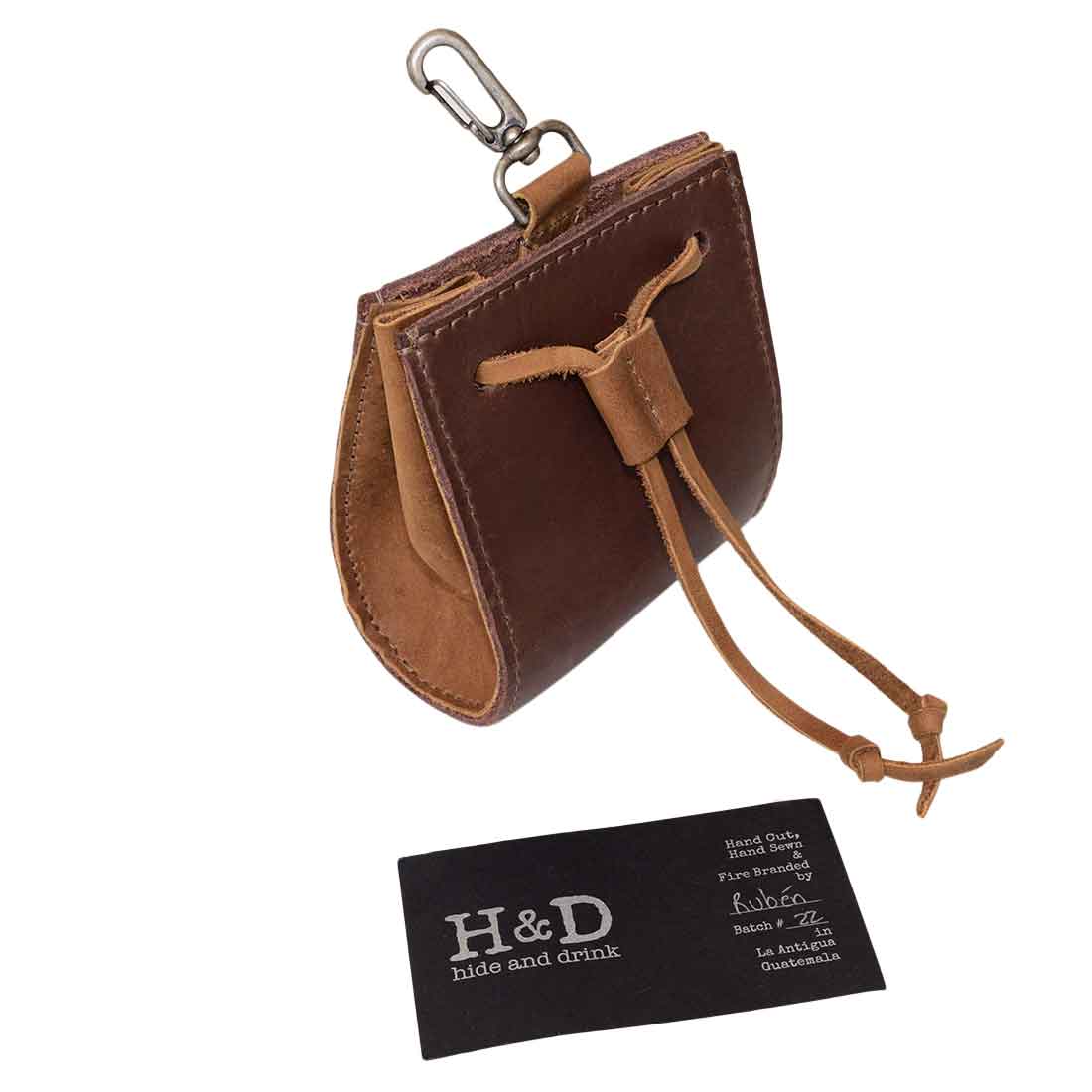 Hide & Drink Old Fashion Coin Case alongside a business card for authenticity, showcasing its premium craftsmanship. This full grain leather wallet is a timeless classic vintage accessory, perfect for everyday use. Old Fashion Coin Case Wallet Cash Bag Pouch Classic Vintage Accessories, Full Grain Leather, StockyardX, Small Batch Production, Hand Cut, Hand Sewn, Fire Branded, Artisan, Handmade in La Antigua Guatemala & Oaxaca Mexico.