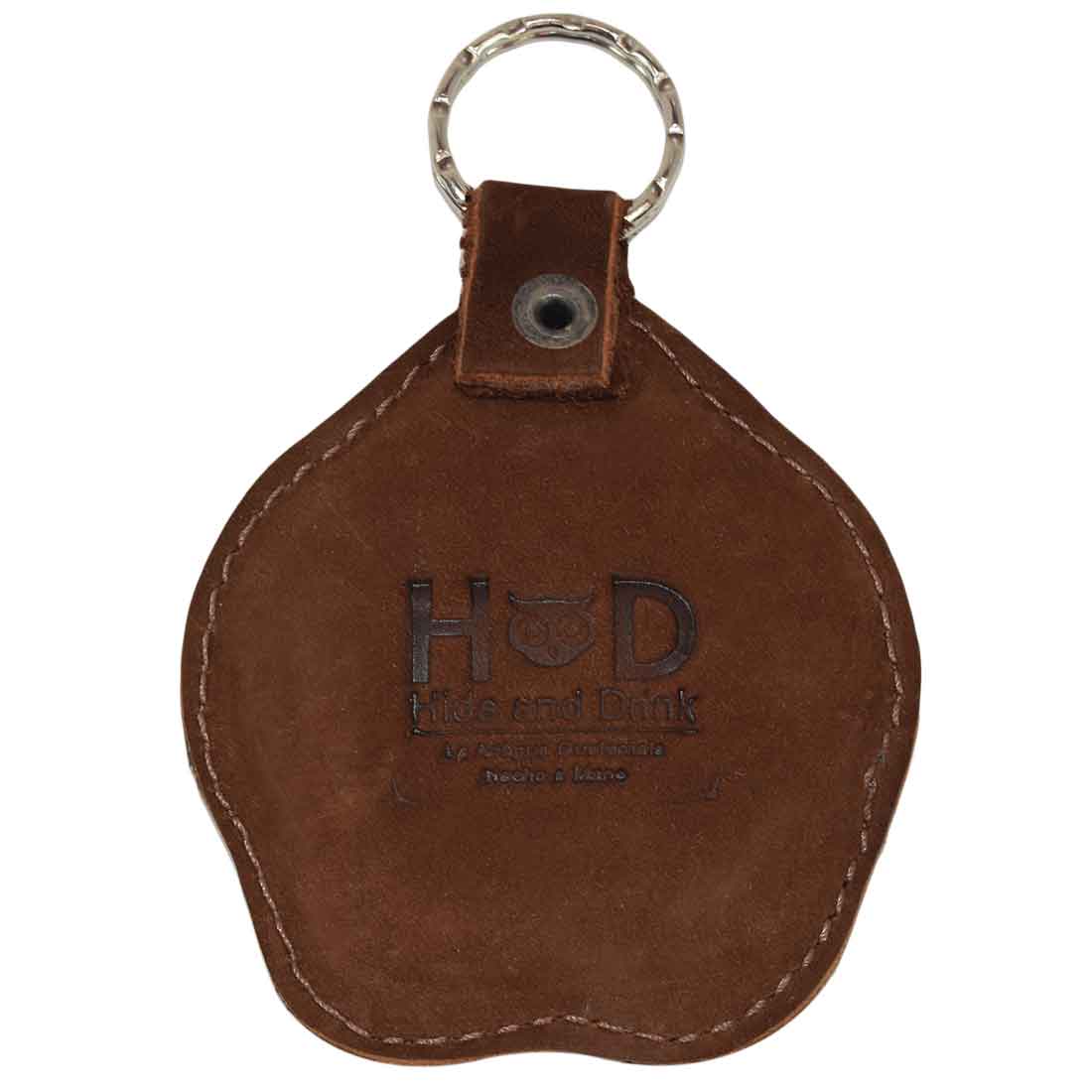 Back view of the Hide & Drink Doggy Paw Keychain displaying the fire branded logo. This beautiful keychain is crafted from suede leather, making it an ideal charm for dog lovers with its small batch production and artisan quality, handmade in La Antigua Guatemala & Oaxaca Mexico.