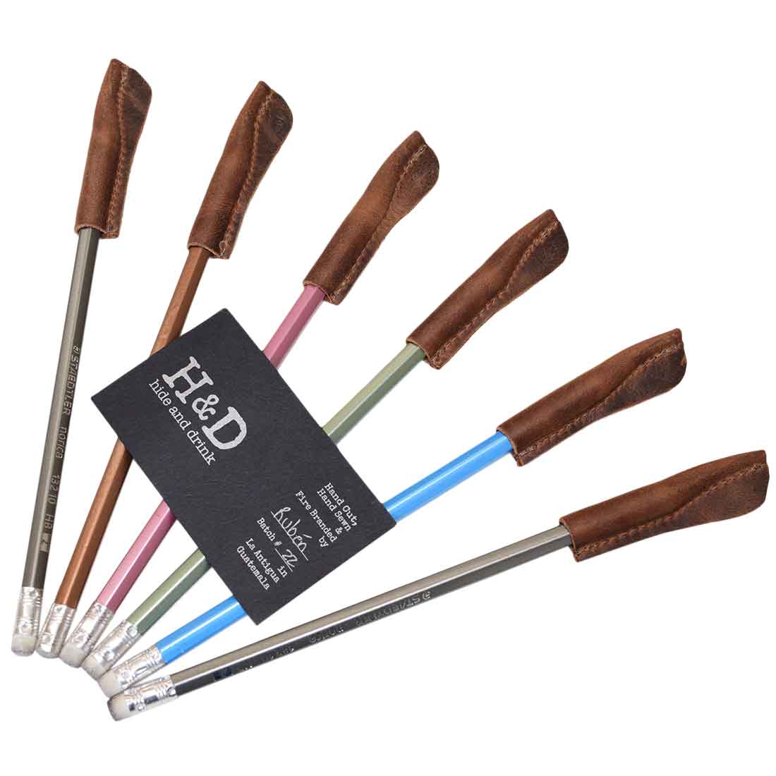Stylish assortment of Hide & Drink Pencil Cap (6 Pack) displaying each leather cap with colored pencils, ideal as unique covers and accessories. Handmade in La Antigua Guatemala & Oaxaca Mexico, these durable pencil lead protectors are designed with artisanal precision.
