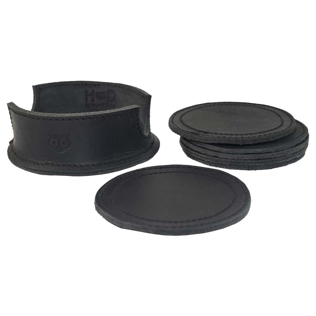 Thick Leather Coasters (6-Pack) by Hide & Drink arranged with multiple charcoal black circular coasters, emphasizing elegant craftsmanship. Made of high-quality full grain leather, this artisan collection features small batch production, each piece carefully hand cut, hand sewn, and fire branded, made in La Antigua Guatemala.