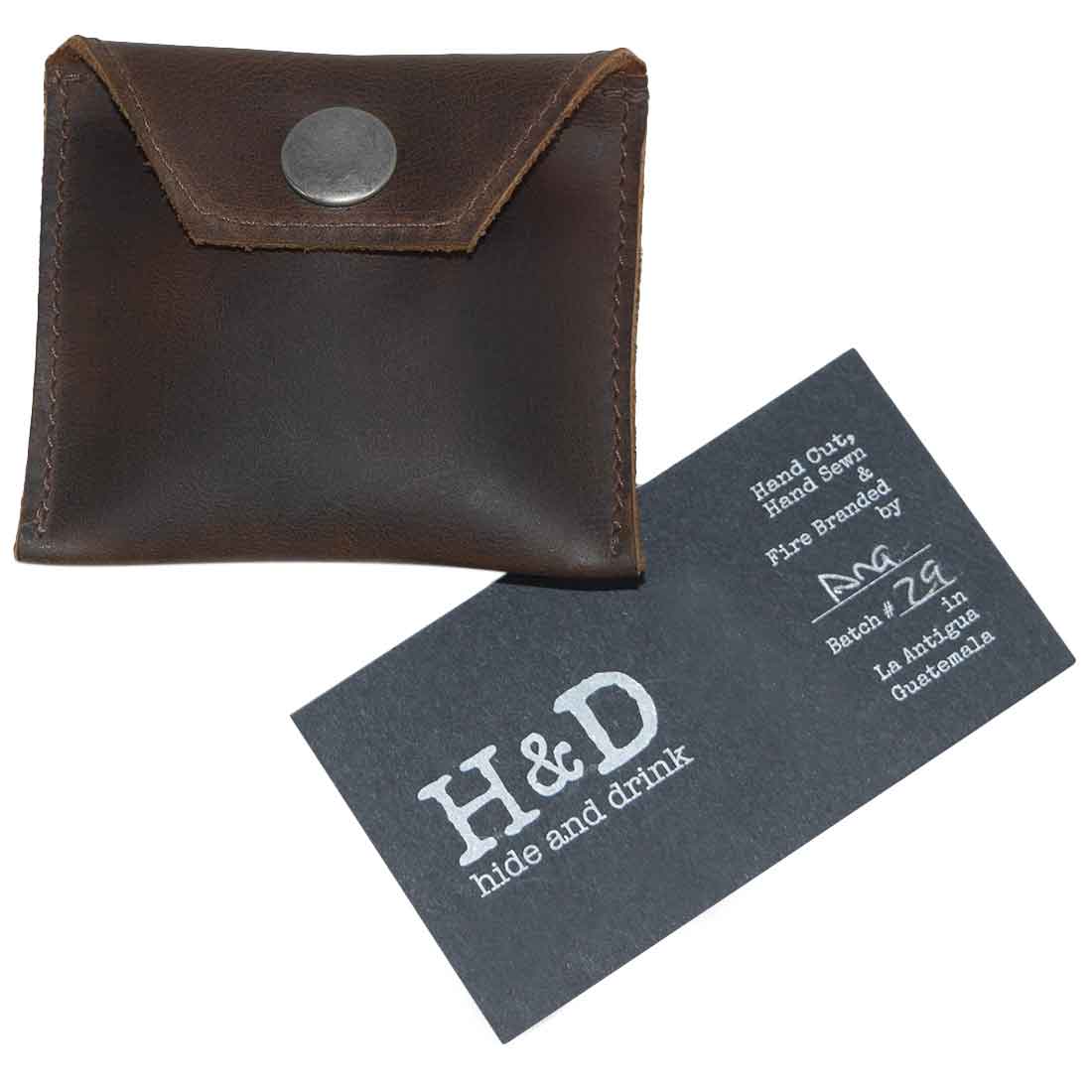Hide & Drink Tampon Case paired with its branded card, emphasizing artisanal quality and small batch production in leather crafting. This pouch serves as a discreet holder for personal items.