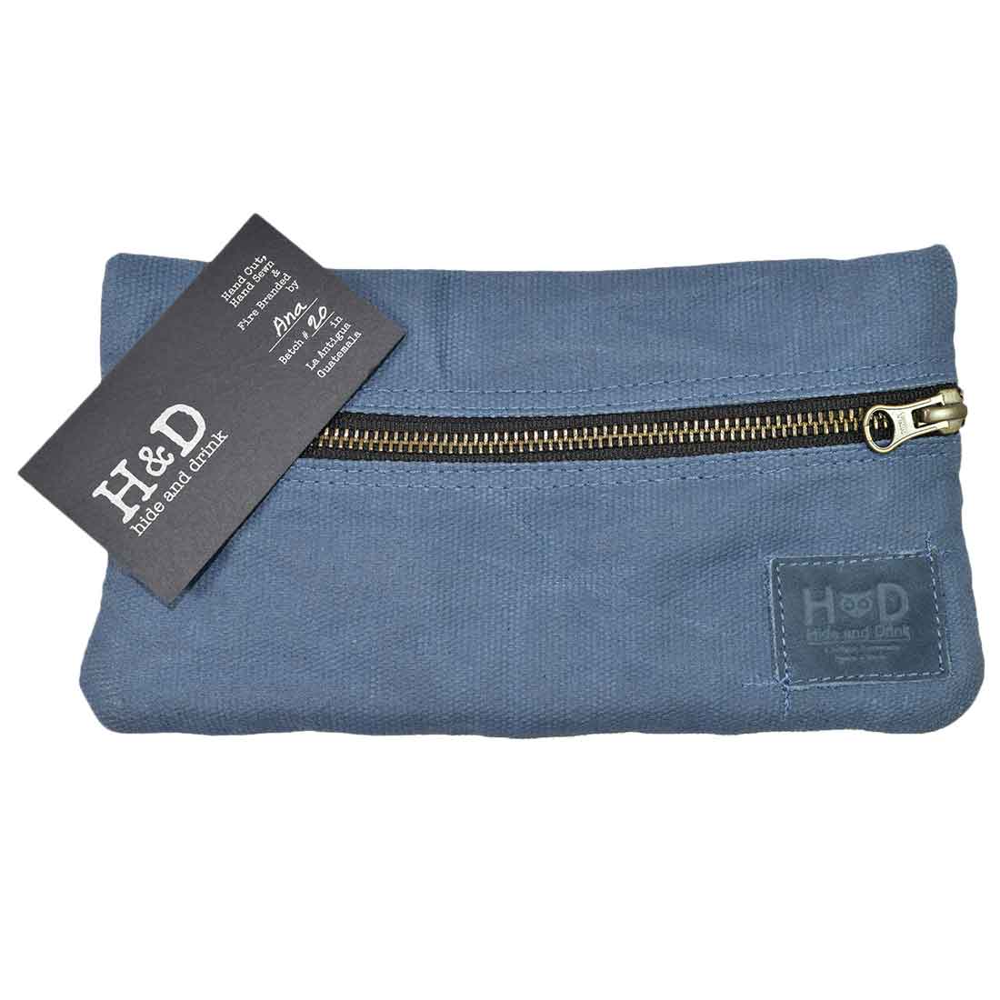 Branding detail on the blue Hide & Drink Vape Pen Case (Accessories not included), ideal for stylish vaping enthusiasts. The perfect Pen Accessories Kit Pouch Holder to ensure a secure fit. G Pen Soft Travel Bag Handmade from Waxed Canvas, Full Grain Leather, StockyardX, Small Batch Production, Hand Cut, Hand Sewn, Fire Branded, Artisan, Handmade in La Antigua Guatemala & Oaxaca Mexico.
