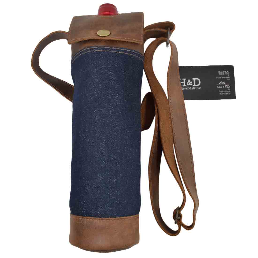 Stylish Hide & Drink Wine Caddy featuring a blend of repurposed denim and full grain leather. This handmade wine carrier tote reflects artisan craftsmanship with hand cut, hand sewn, and fire branded details, representing small batch production in La Antigua Guatemala and Oaxaca Mexico.